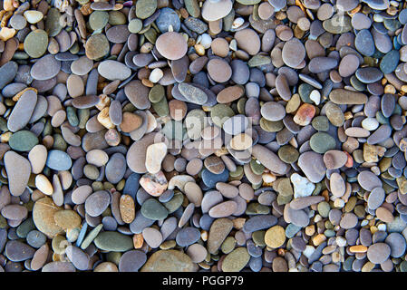 Background texture of multicolored stones on the beach. Stock Photo