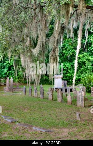 Old southern grave yard in South Carolina - Graveyard in the South United States with Spanish moss and old headstones visible - Tillandsia usneoides Stock Photo