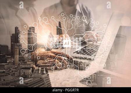 Double exposure of success businessman working in office with digital tablet laptop computer with London building and smart phone,filter effect Stock Photo