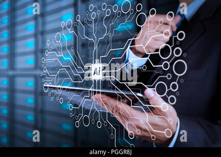 Artificial Intelligence (AI),machine learning with data mining technology on virtual dachboard.businessman hand using tablet computer and server room  Stock Photo