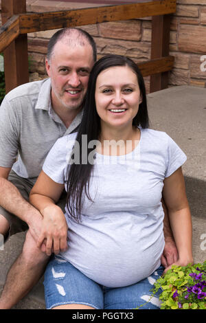 Caring husband embraces wife with love, have glad expressions, holds paper  documents, discuss banking procedures, study bills, drink tea or coffee,  pose indoor, enjoy calm domestic atmosphere 9008724 Stock Photo at Vecteezy