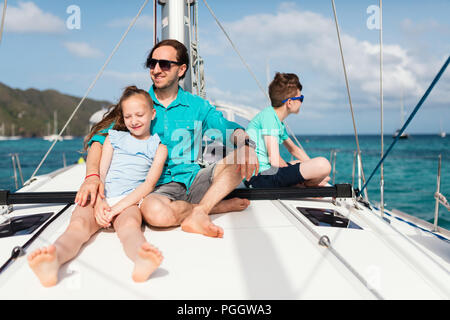 Father and kids on board of sailing yacht having summer travel adventure Stock Photo