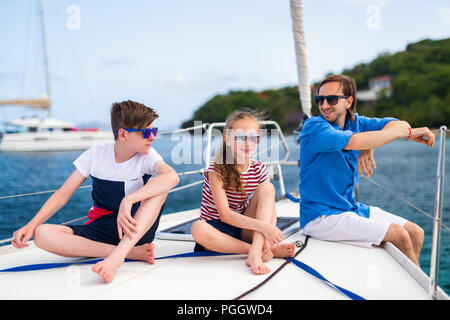 Father and kids on board of sailing yacht having summer travel adventure Stock Photo