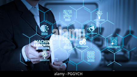 Machine learning technology diagram with artificial intelligence (AI),neural network,automation,data mining in VR screen.businessman hand use smart ph Stock Photo