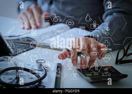 Health care and medical services concept with flat line AR interface.Healthcare costs and fees concept.Hand of smart doctor used a calculator for medi Stock Photo