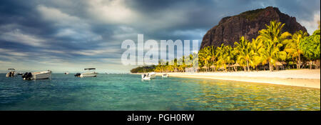 White sandy beach and Le Morn Brabant at sunset.  Beautiful  Mauritius landscape. Panorama Stock Photo