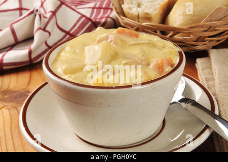 A cup of chicken corn chowder with dinner rolls Stock Photo