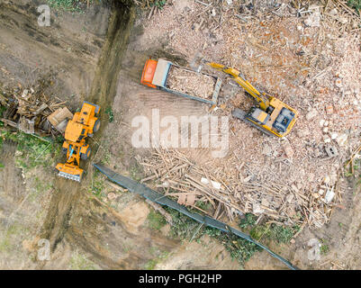 excavator and dump truck clearing out site after demolition of old ...