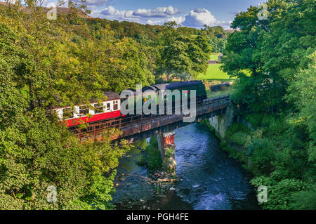 The City of Wells steam locomotive on the East Lancashire Railway crossing the river Irwell at Edenfield.. Stock Photo