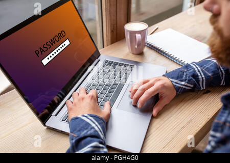 Cropped image of a young man working on his laptop in a coffee shop, rear view of business man hands busy using laptop at office desk, young male stud Stock Photo