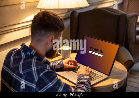 Cropped image of a young man working on his laptop in a coffee shop, rear view of business man hands busy using laptop at office desk, young male stud Stock Photo