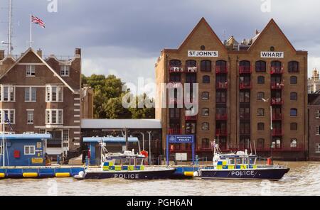 September 2017 - Police boat moored at a pontoon at Thames river near Marine Policing Unit headquarters on Wapping High Street in London, UK Stock Photo