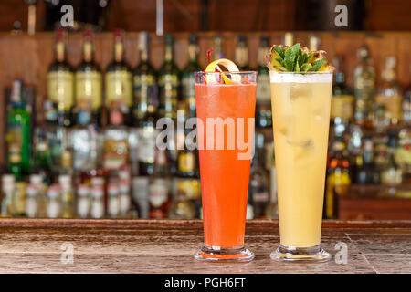 Two multi-colored cocktails on the bar, a place for writing text or a recipe Stock Photo
