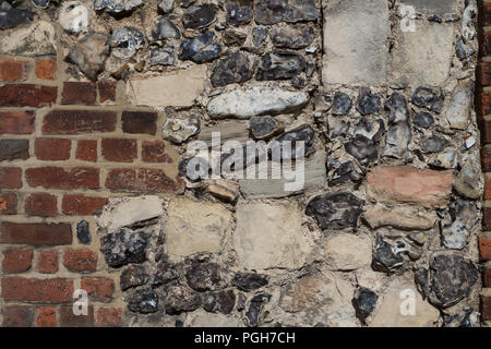 a wall of a house in Canterbury, Kent, England, partially made of ancient stones and partially from modern bricks Stock Photo