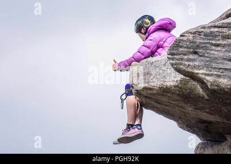 Young female rock climber wearing bikini on challenging route on cliff ...