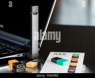Juul Charger Laptop Juul nicotine vapor dispenser charging in USB charger  Stock Photo
