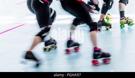 Roller derby skaters close up of legs and feet. Motion blur action pan shot Stock Photo