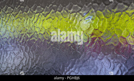 Background of opaque glass with a green horizontal strip. Close-up of bumpy grainy texture. Frosted window pane, rough wavy relief pattern, dim glow. Stock Photo