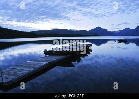 Boats loaded up on the dock at Lake Mcdonald in Glacier National Park Stock Photo