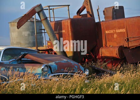 Forgotten equipment rusts on a farm Stock Photo