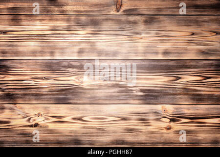 Wooden background from wood pine burnt paint brush abstract texture annual rings places knots prefabricated boards for covering parquet laminate pictu Stock Photo