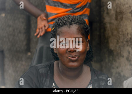 ACCRA, GHANA - Jan 8, 2017: Unidentified Ghanaian woman smiles at the local market. People of Ghana suffer of poverty due to the economic situation Stock Photo