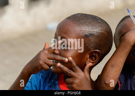 ACCRA, GHANA - Jan 8, 2017: Unidentified Ghanaian kids play at the local market. People of Ghana suffer of poverty due to the economic situation Stock Photo