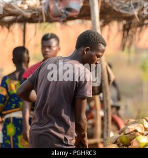 OUIDAH, BENIN - Jan 10, 2017: Unidentified Beninese man works at the local market. Benin people suffer of poverty due to the bad economy Stock Photo