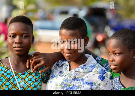 OUIDAH, BENIN - Jan 10, 2017: Unidentified Beninese beautiful girls at the local market. Benin people suffer of poverty due to the bad economy Stock Photo