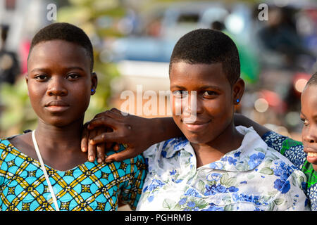 OUIDAH, BENIN - Jan 10, 2017: Unidentified Beninese beautiful girls at the local market. Benin people suffer of poverty due to the bad economy Stock Photo