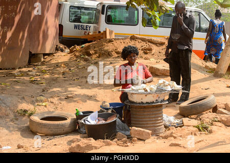 CENTRAL REGION, GHANA - Jan 17, 2017: Unidentified Ghanaian woman chops some vegetable in local village. People of Ghana suffer of poverty due to the  Stock Photo