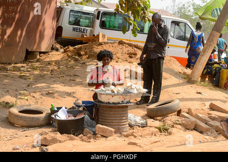 CENTRAL REGION, GHANA - Jan 17, 2017: Unidentified Ghanaian woman chops some vegetable in local village. People of Ghana suffer of poverty due to the  Stock Photo