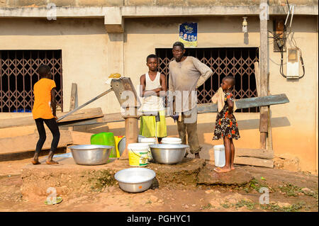 CENTRAL REGION, GHANA - Jan 17, 2017: Unidentified Ghanaian people pour the water into the basins in local village. People of Ghana suffer of poverty  Stock Photo