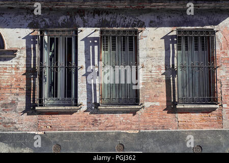 three windows in a old building Stock Photo