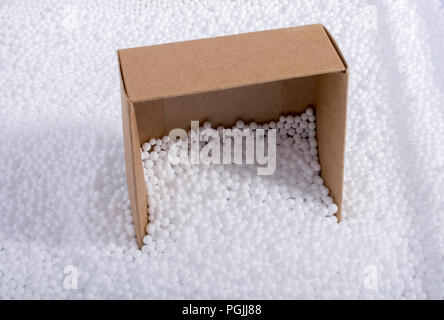 Box on little  white polystyrene foam balls Stock Photo