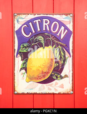 SWINDON, UK - AUGUST 18, 2018: Old Citron Enamel sign on a red wooden background Stock Photo