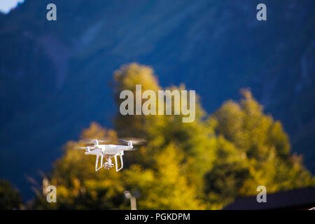 Photo of quadcopter against blue sky, bridge Stock Photo