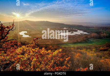 Sun going down over the lake at autumn Stock Photo