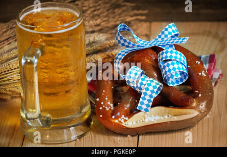 Pretzel with glass of beer on wood table,Oktober background. Stock Photo