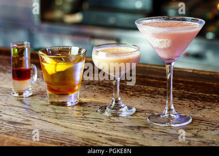 A variety of cocktails in glasses of different shapes in a nightclub on the bar, space for text Stock Photo