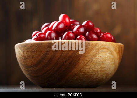 dogwood in a wooden plate on a wooden background Stock Photo