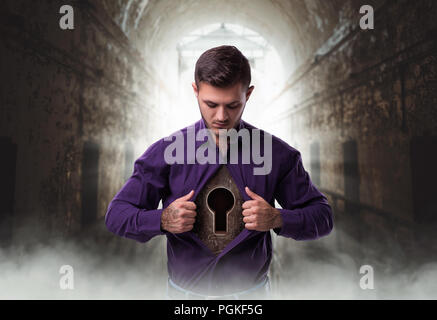 Man with keyhole in chest, lock from the heart abandoned house on background Stock Photo