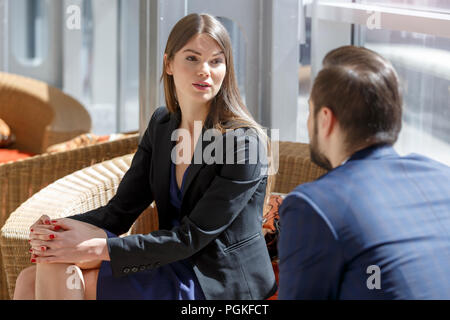Business partners talking at break sitting at lobby at business center Stock Photo