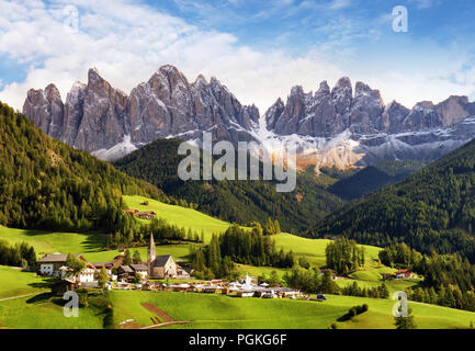 Val di Funes, Trentino Alto Adige, Italy. The great autumnal colors shines under the late sun with Odle on the background and Santa Magdalena Village  Stock Photo