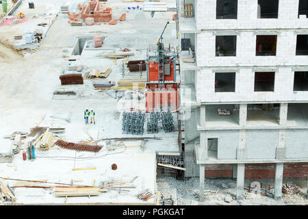 Wide angle shot of construction site with crew workers discussing project, copy space Stock Photo