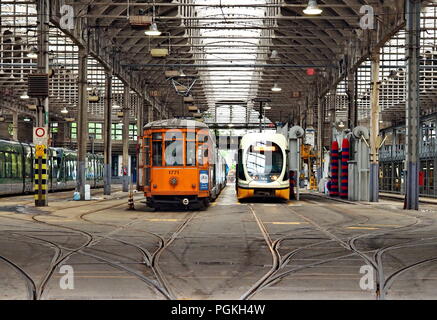 MILAN, ITALY - MAY 28, 2018: Trams parked at the tram depot in Pietro Custodi Street near Porta Ticinese ,May 2018 in Milan Stock Photo