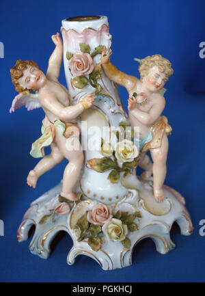 Antique porcelain candleholder with two cherubs Stock Photo