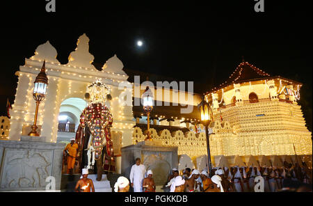 Sri Lanka. 25th Aug, 2018. An elephant decorated for the Esala Perahera festival is lead past Sri Lankan Buddhist Temple of the Tooth in the ancient hill capital of Kandy, some 116 km from Colombo on August 25, 2018. The festival features a night procession of Kandyan dancers, fire twirlers, traditional musicians, acrobatic fire performers and elephants, gathering thousands of tourists and spectators from around the island. Credit: Pradeep Dambarage/Pacific Press/Alamy Live News Stock Photo