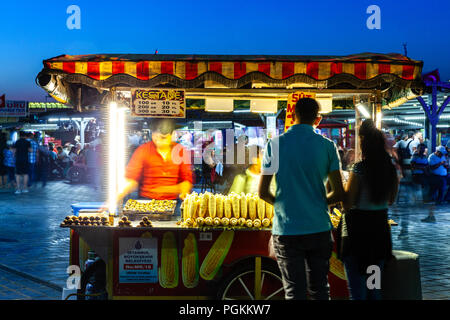 ISTANBUL, TURKEY - AUGUST 14: Street food vendor sells corn cobs and roasted chestnuts on the street of Istanbul on August 14, 2018 in Istanbul, Turke Stock Photo