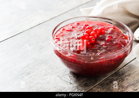 Cranberry sauce in bowl for Thanksgiving dinner on wooden table Stock Photo